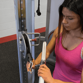 Woman adjusting the pulley system on a PCL2 Functional Trainer with 160lb weight stack.